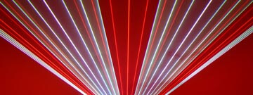 Red, white, and purple lasers fanning out